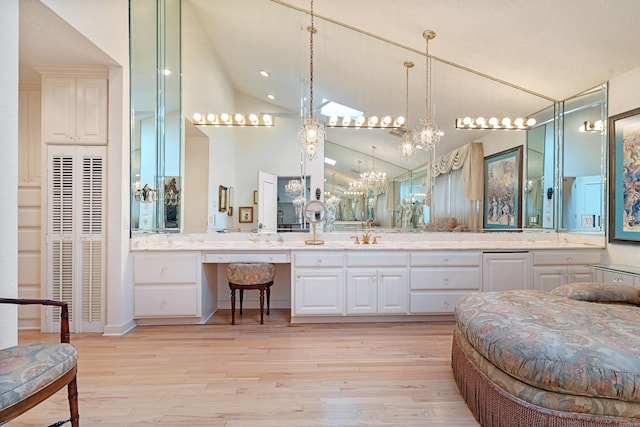 5000 Central Ave Unit 26-27, Hot Springs, AR 71913 - bathroom with wood finished floors, a heating unit, a chandelier, vanity, and high vaulted ceiling