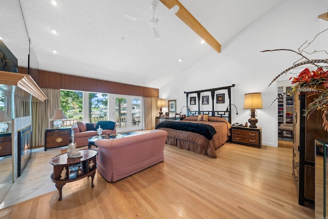 5000 Central Ave Unit 26-27, Hot Springs, AR 71913 - bedroom with a glass covered fireplace, light wood-style flooring, high vaulted ceiling, beamed ceiling, and recessed lighting