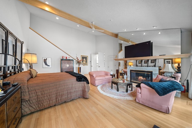 5000 Central Ave Unit 26-27, Hot Springs, AR 71913 - bedroom with wood finished floors, beamed ceiling, recessed lighting, high vaulted ceiling, and a glass covered fireplace