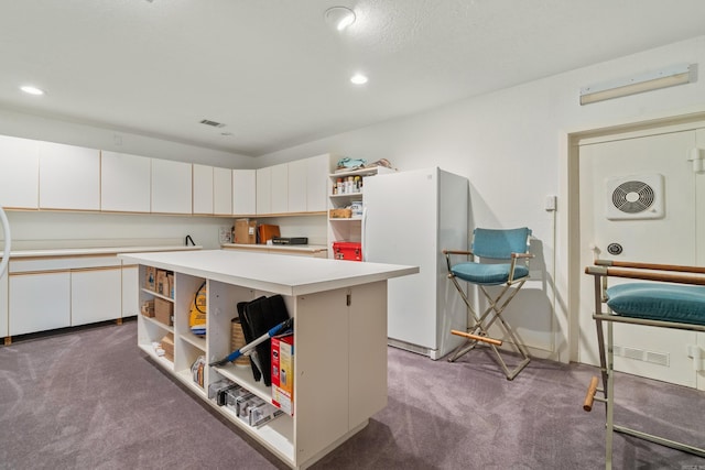 5000 Central Ave Unit 26-27, Hot Springs, AR 71913 - kitchen with open shelves, freestanding refrigerator, carpet floors, light countertops, and white cabinets