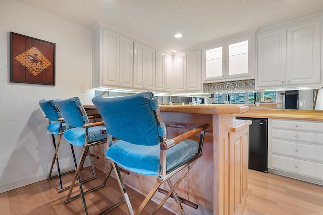5000 Central Ave Unit 26-27, Hot Springs, AR 71913 - bar with light wood finished floors, dishwasher, recessed lighting, and a textured ceiling
