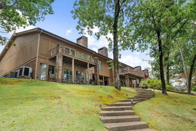 5000 Central Ave Unit 26-27, Hot Springs, AR 71913 - rear view of property featuring a chimney, a yard, and cooling unit