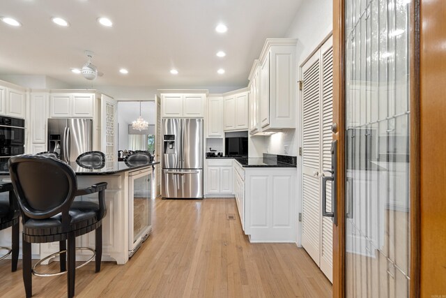 5000 Central Ave Unit 26-27, Hot Springs, AR 71913 - kitchen featuring stainless steel fridge, a breakfast bar, light wood finished floors, oven, and recessed lighting