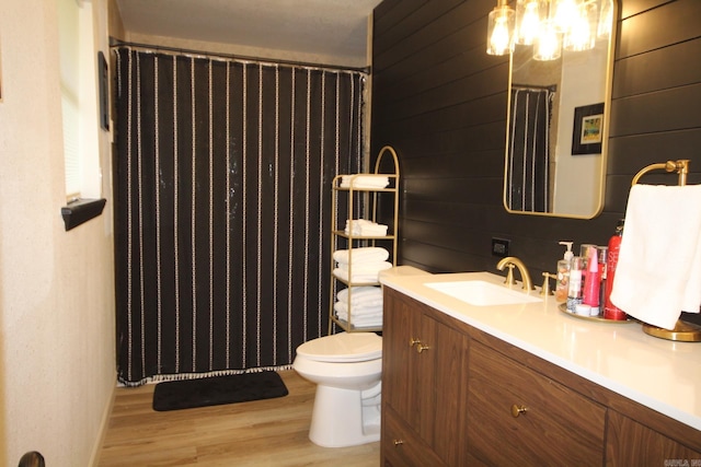 1108 N 14th St, Nashville, AR 71852 - full bathroom with wood finished floors, toilet, vanity, and a shower with shower curtain