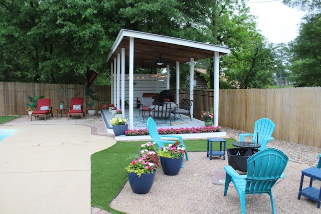 1108 N 14th St, Nashville, AR 71852 - view of patio / terrace featuring a fire pit, ceiling fan, and a fenced backyard