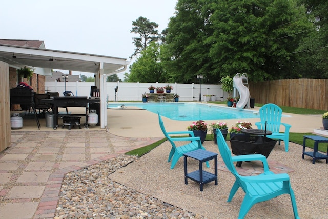 1108 N 14th St, Nashville, AR 71852 - view of pool featuring a water slide, a fenced backyard, and a patio