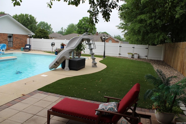 1108 N 14th St, Nashville, AR 71852 - view of swimming pool with a water slide, a playground, a patio, and a gate