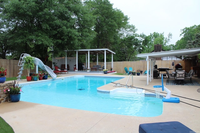 1108 N 14th St, Nashville, AR 71852 - view of pool featuring a water slide, a patio area, and a fenced backyard