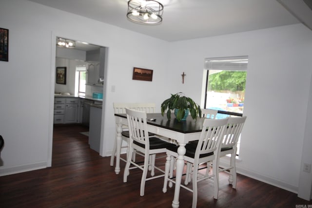 1108 N 14th St, Nashville, AR 71852 - dining room featuring dark wood-style floors, healthy amount of natural light, baseboards, and a chandelier