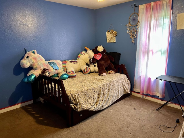 bedroom with multiple windows, carpet, and baseboards