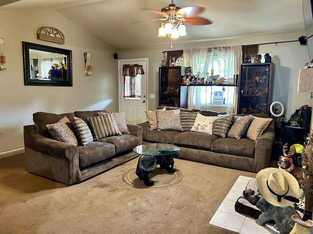 carpeted living area with ceiling fan, vaulted ceiling, and baseboards