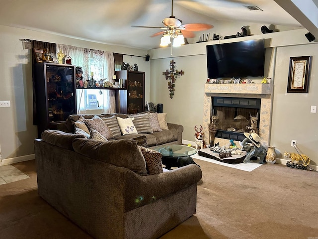 living room featuring a fireplace, ceiling fan, baseboards, and lofted ceiling