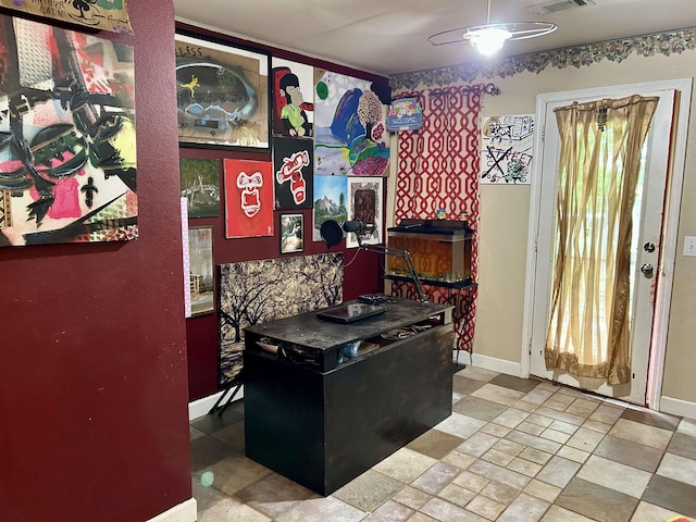 interior space with ceiling fan and baseboards
