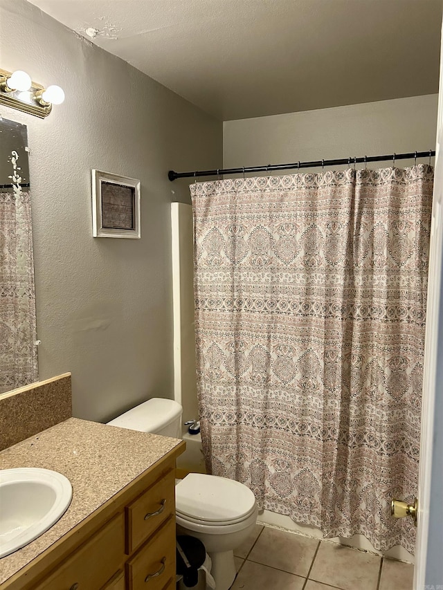 bathroom with tile patterned flooring, vanity, toilet, and shower / tub combo