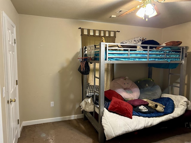 bedroom featuring concrete flooring, baseboards, and a ceiling fan