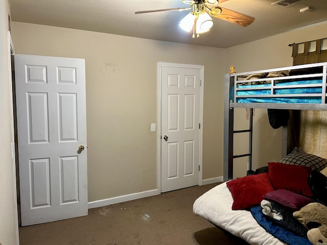 carpeted bedroom featuring baseboards and ceiling fan