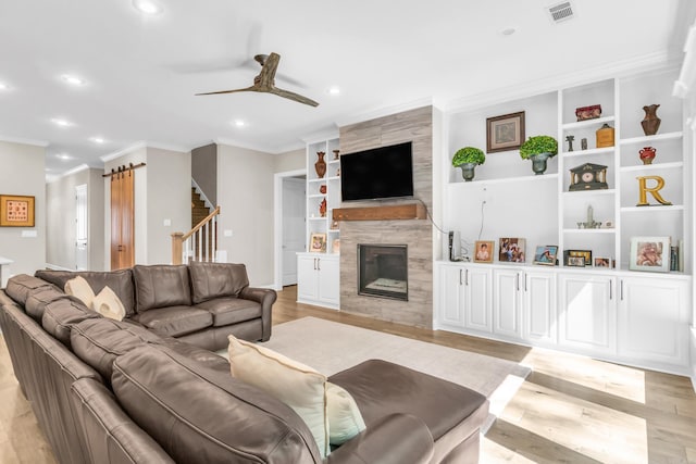 17 Cove Creek Pt, Little Rock, AR 72211 - living area with a ceiling fan, light wood-style flooring, recessed lighting, crown molding, and a fireplace