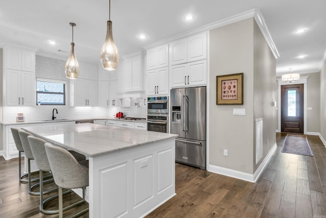 17 Cove Creek Pt, Little Rock, AR 72211 - kitchen featuring stainless steel appliances, ornamental molding, baseboards, decorative backsplash, and white cabinets