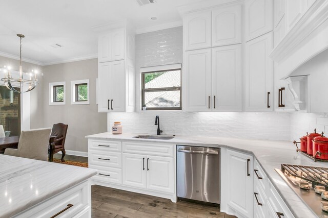 17 Cove Creek Pt, Little Rock, AR 72211 - kitchen featuring appliances with stainless steel finishes, a sink, a chandelier, decorative backsplash, and crown molding