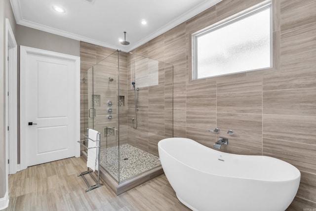 17 Cove Creek Pt, Little Rock, AR 72211 - bathroom with a shower stall, tile walls, a freestanding bath, crown molding, and wood finished floors
