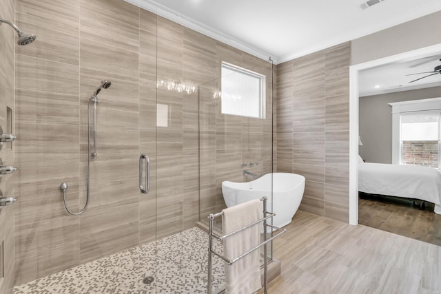 17 Cove Creek Pt, Little Rock, AR 72211 - full bathroom featuring healthy amount of natural light, a stall shower, tile walls, a freestanding tub, and a ceiling fan