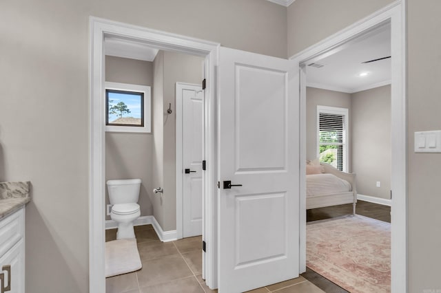 17 Cove Creek Pt, Little Rock, AR 72211 - bathroom featuring crown molding, toilet, baseboards, tile patterned flooring, and vanity