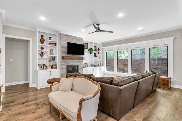 17 Cove Creek Pt, Little Rock, AR 72211 - living room with crown molding, ceiling fan, a premium fireplace, baseboards, and wood finished floors