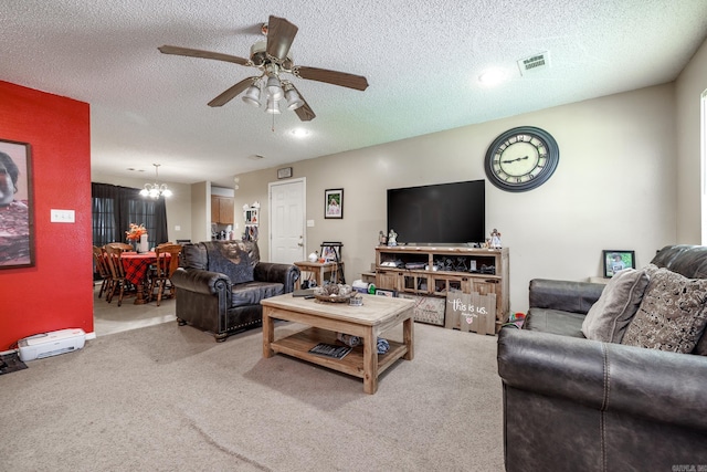 living area featuring a chandelier, carpet, ceiling fan, and a textured ceiling