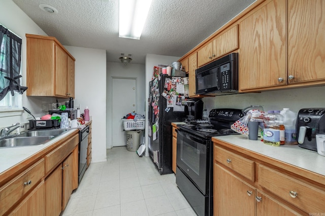 kitchen with black appliances, light countertops, a textured ceiling, and a sink