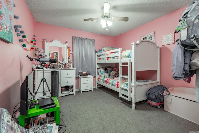 carpeted bedroom with a textured ceiling and a ceiling fan