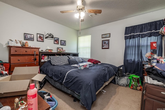 bedroom with carpet flooring, a textured ceiling, and ceiling fan