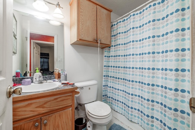 bathroom featuring vanity, curtained shower, and toilet