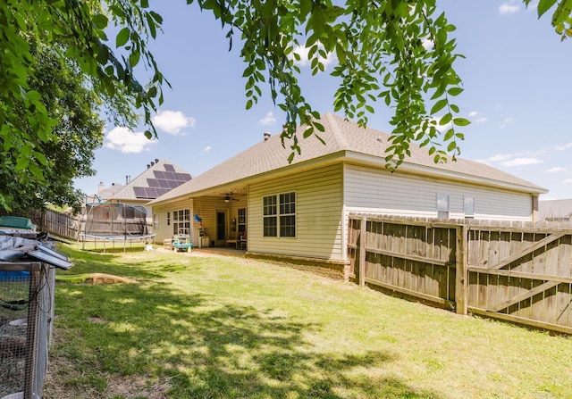 51 Waters Edge Dr, Little Rock, AR 72204 - back of house with a trampoline, a ceiling fan, and a shingled roof