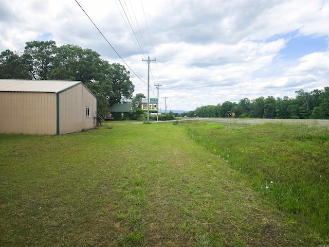 163 Junior Cir, Clinton, AR 72031 - view of grassy yard featuring an outbuilding