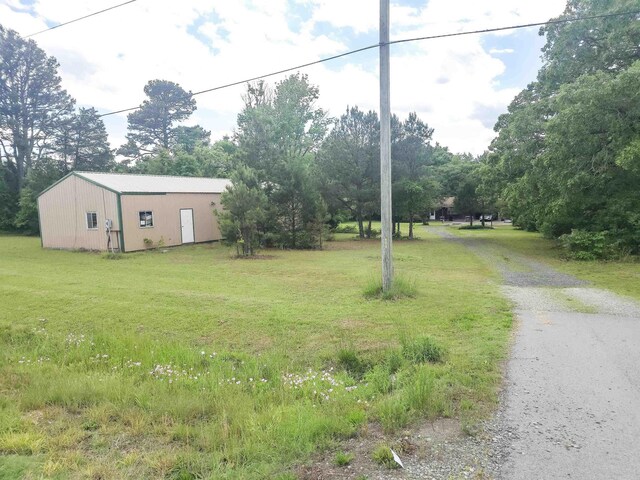 163 Junior Cir, Clinton, AR 72031 - view of grassy yard with an outbuilding and view of scattered trees