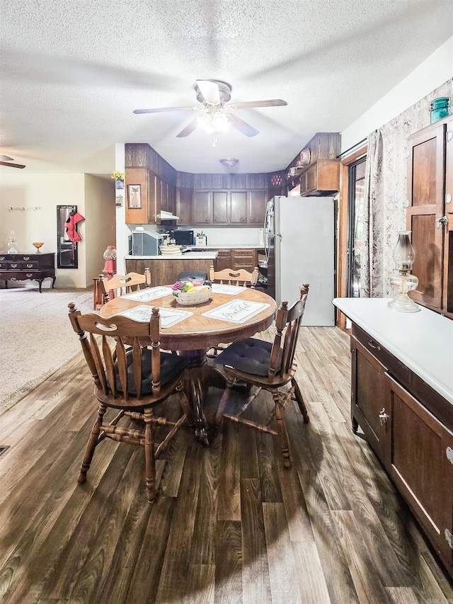163 Junior Cir, Clinton, AR 72031 - dining area featuring a ceiling fan, wood finished floors, and a textured ceiling
