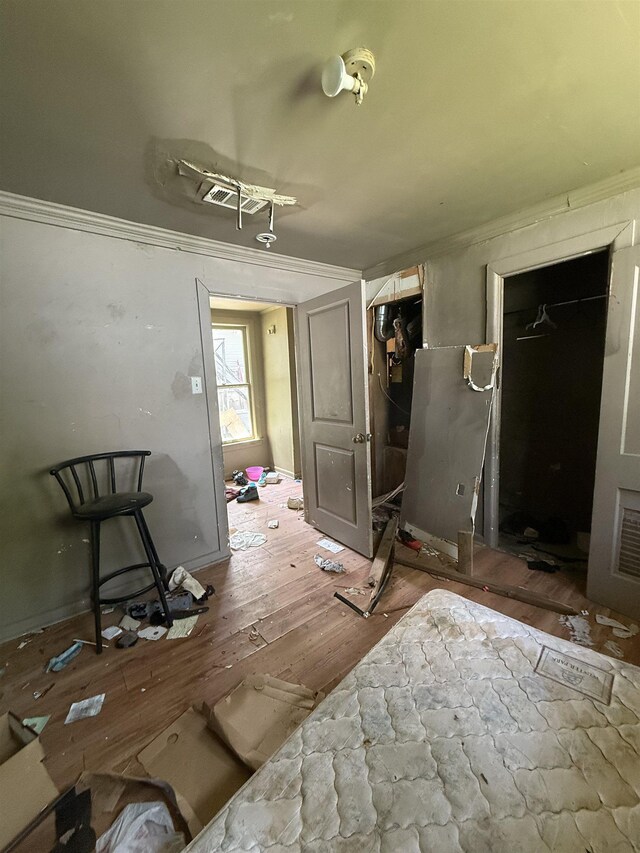 dining space with ornamental molding and wood finished floors