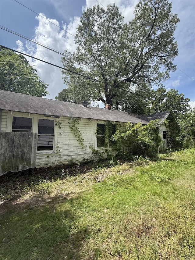 view of property exterior with a yard