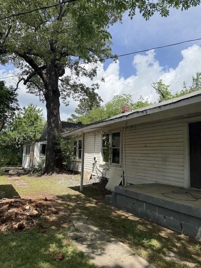 view of side of home featuring a chimney