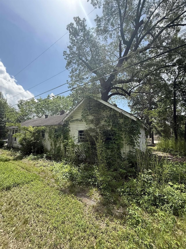 view of property exterior featuring a yard and a chimney
