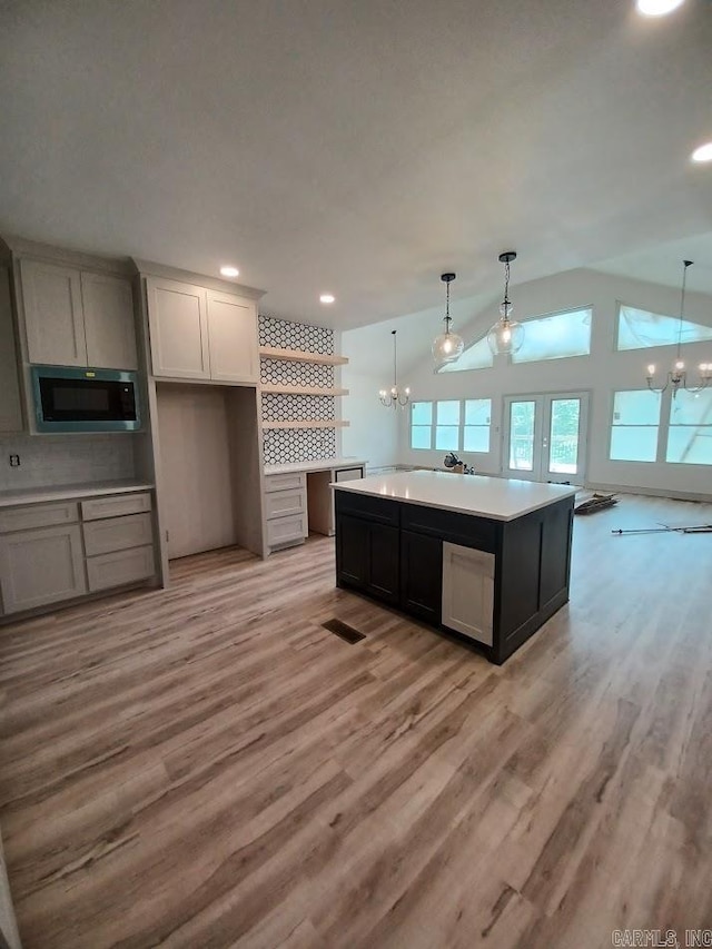 32 Propio Way, Hot Springs Village, AR 71909 - kitchen with a chandelier, built in microwave, light wood-type flooring, a kitchen island, and recessed lighting