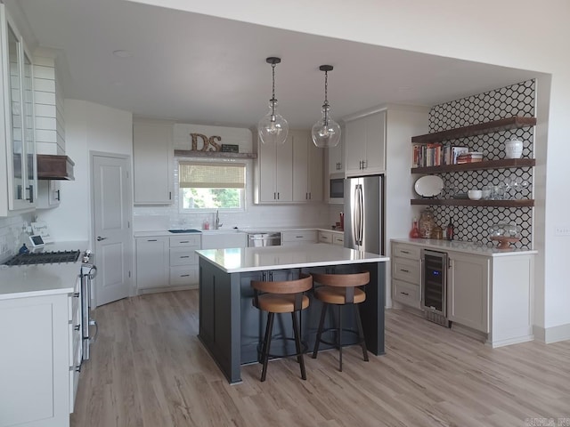 32 Propio Way, Hot Springs Village, AR 71909 - kitchen featuring wine cooler, stainless steel appliances, open shelves, and light wood finished floors