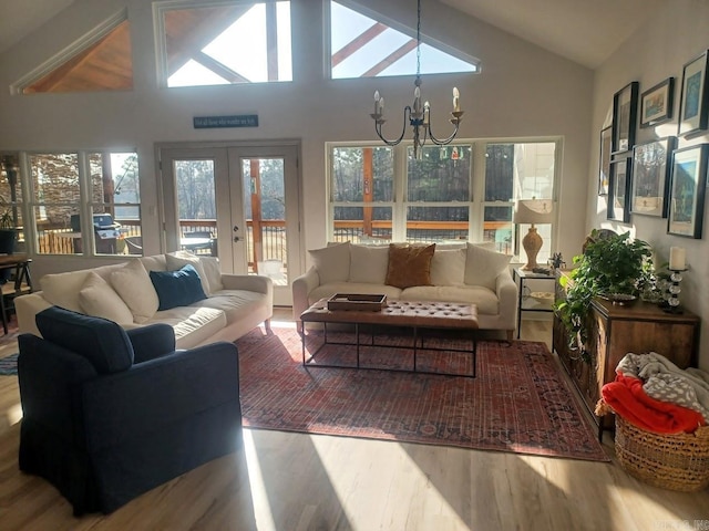 32 Propio Way, Hot Springs Village, AR 71909 - living room with wood finished floors, a chandelier, lofted ceiling, and french doors