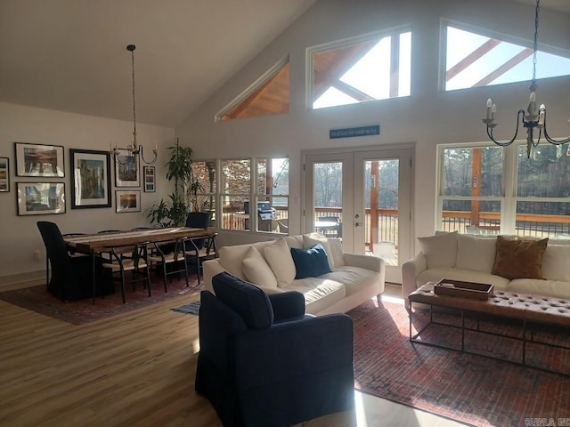 32 Propio Way, Hot Springs Village, AR 71909 - living area featuring a chandelier, wood finished floors, high vaulted ceiling, and french doors