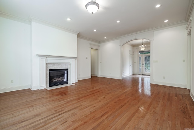 134 Myrick Ln, Hot Springs, AR 71913 - unfurnished living room with arched walkways, light wood finished floors, recessed lighting, ornamental molding, and a tile fireplace