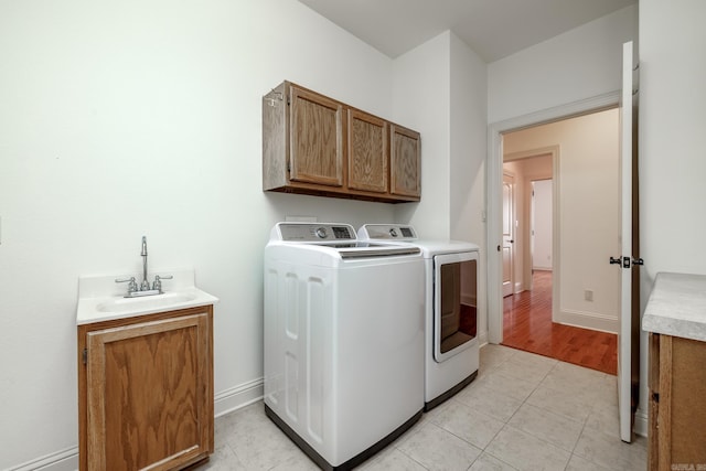 134 Myrick Ln, Hot Springs, AR 71913 - laundry room with cabinet space, washer and clothes dryer, baseboards, and light tile patterned floors
