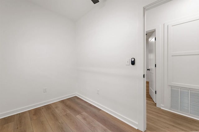 empty room with wood finished floors, baseboards, and a ceiling fan