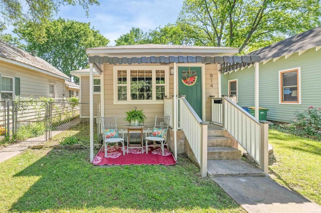 view of front of property featuring a gate and a patio area
