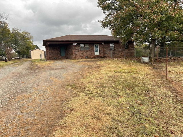 18 Garland Spgs, Mount Vernon, AR 72111 - rear view of property with a storage unit, fence, an outbuilding, driveway, and brick siding