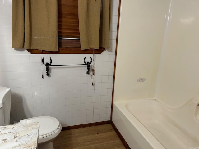 18 Garland Spgs, Mount Vernon, AR 72111 - full bathroom featuring toilet, wood finished floors, tile walls, a tub to relax in, and a shower